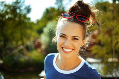 happy trendy solo tourist woman on river boat river cruising clipart