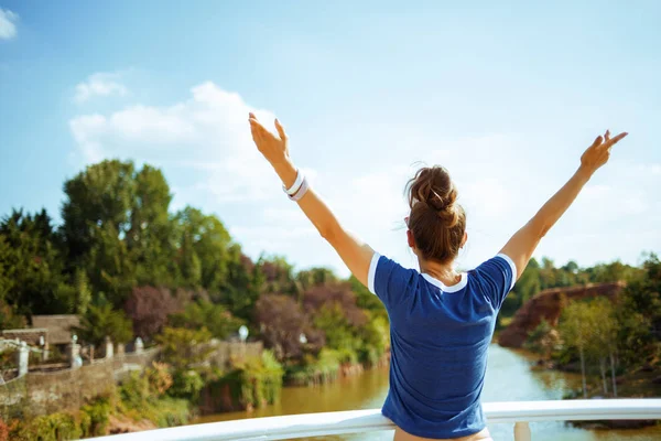 Tourist woman on river boat rejoicing while having river voyage — Stock Photo, Image