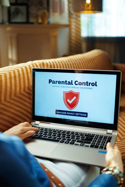 Joven ama de casa configuración control parental en el ordenador portátil —  Fotos de Stock