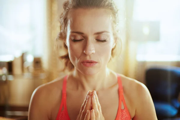 Relaxed young sports woman at modern home meditating — Stock Photo, Image