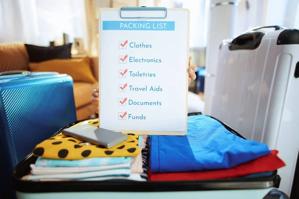 Closeup on young traveller woman showing packing list — Stock Photo, Image