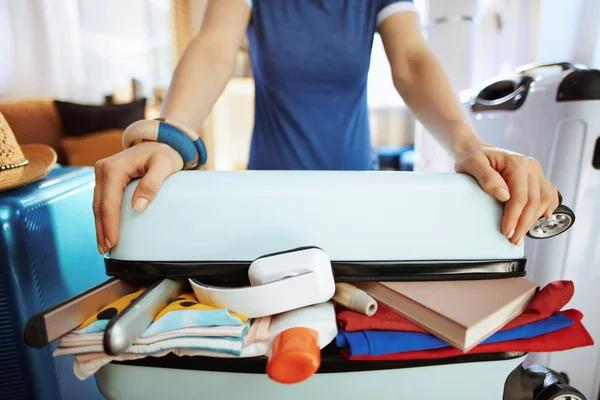 Primer plano de la mujer viajera tratando de cerrar sobre maleta empacada — Foto de Stock