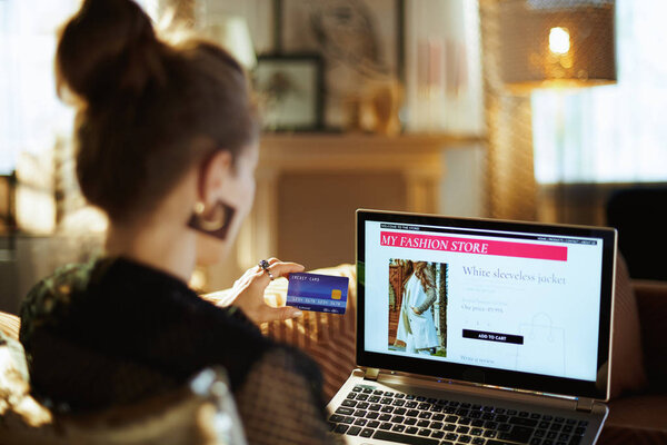 housewife with credit card buying clothes while shop online