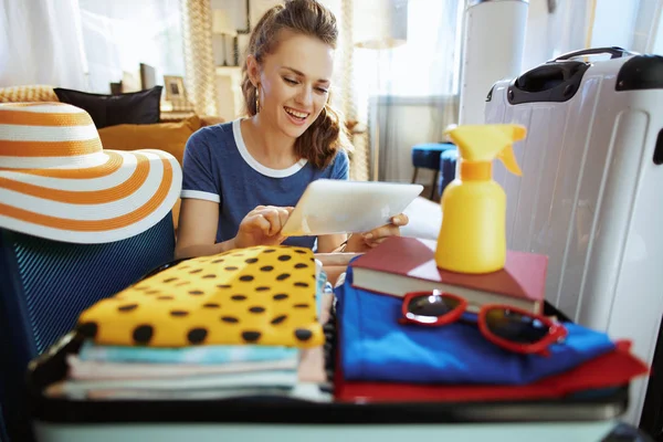 Woman at modern home in sunny summer day booking plane ticket — Stock Photo, Image