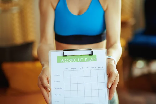 Closeup on fit sports woman in modern house showing meal plan — Stock Photo, Image