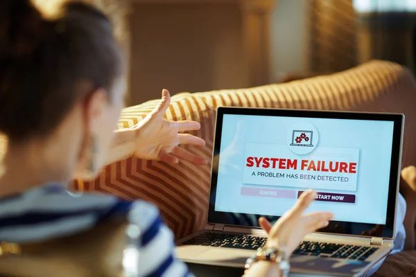 Angry modern woman looking at computer error screen on laptop — Stock Photo, Image