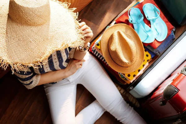 modern woman with big summer hat planning summer vacation