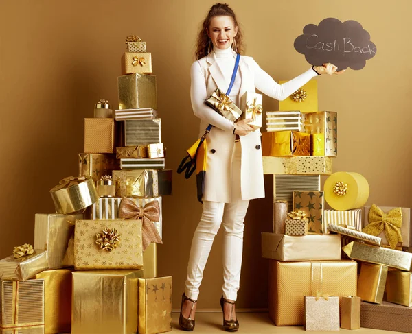 Happy shopper woman with present boxes showing CashBack sign — Stock Photo, Image