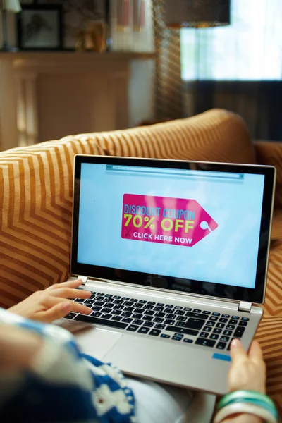 modern woman with summer sale coupon on laptop