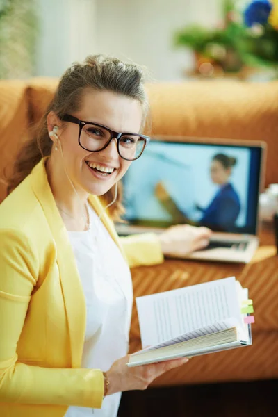 Happy Trendy Middle Age Housewife Yellow Jacket White Headphones Textbook — Stock Photo, Image