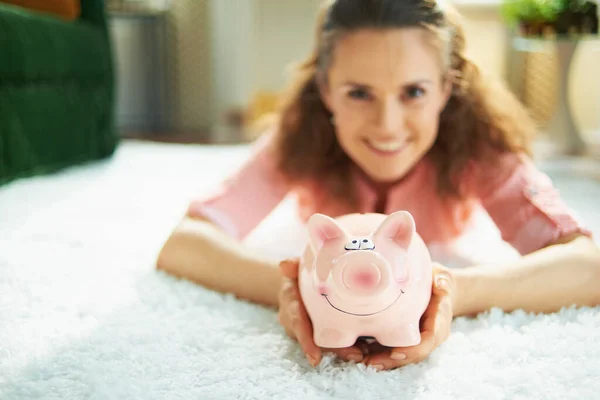 Closeup Happy Woman Blouse White Pants Piggy Bank While Laying — Stock Photo, Image
