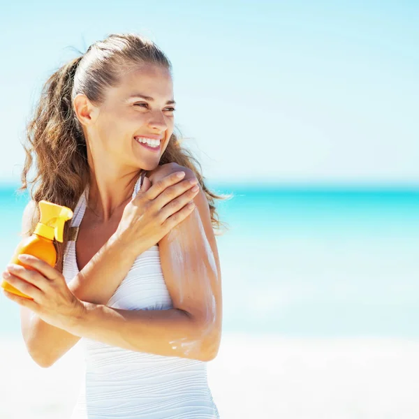 Giovane Donna Sulla Spiaggia Applicando Crema Solare Guardando Sullo Spazio — Foto Stock