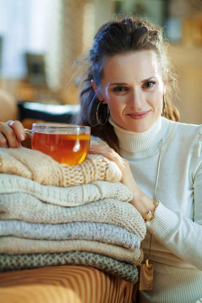 Portrait Smiling Young Housewife White Sweater Skirt Pile Sweaters Cup — Stock Photo, Image