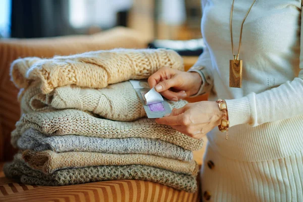 Closeup Modern Female White Sweater Skirt Sitting Couch Pile Sweaters — Stock Photo, Image