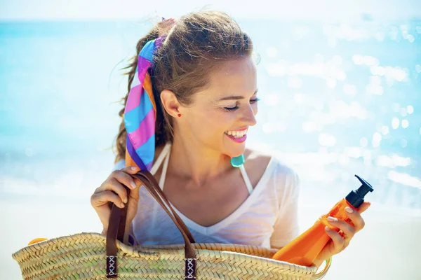 Happy Trendy Woman White Shirt Beach Taking Orange Spf Bottle — Stock Photo, Image