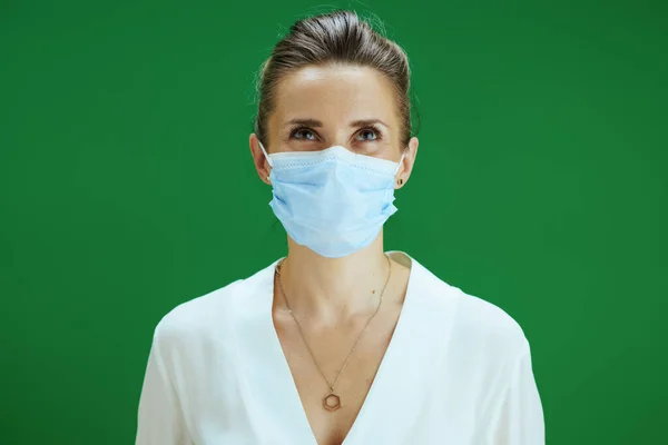 Covid 19大流行病期间的生活 现代女教师 身穿白色衬衫 戴着医疗面罩 隔离在黑板绿色中 — 图库照片