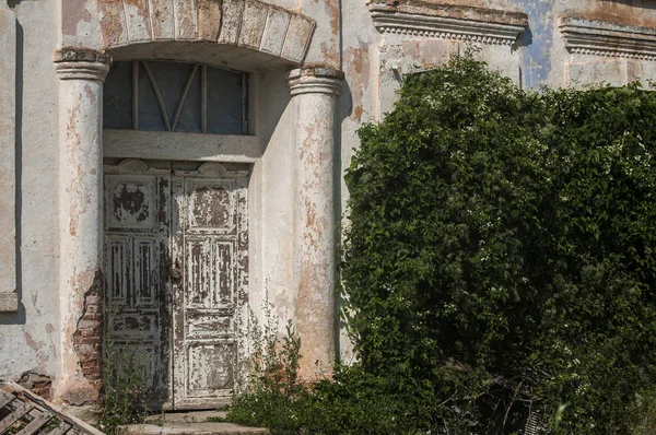 Eski yıpranmış grunge ihmal edilen ülke ev kapı closeup güneşli bir günde terk.