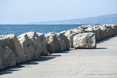 Açık güneşli yaz gününde beyaz taşlarla sahil şeridi