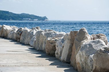 Açık güneşli yaz gününde beyaz taşlarla sahil şeridi