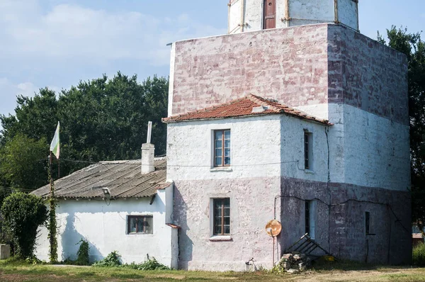 晴れた夏の日に古い大きな海洋灯台の閉鎖の底に家 — ストック写真