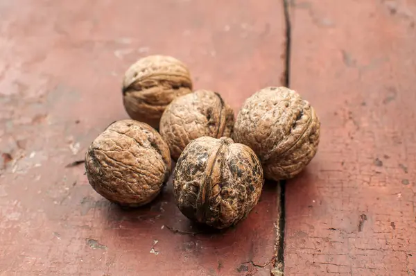 Whole Walnut Shells Closeup Old Wooden Boards Surface Background — Stockfoto