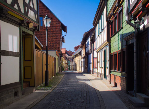 Wernigerode, Germany - July 10, 2015: Narrow street with beautiful houses. Deserted alley in the morning.