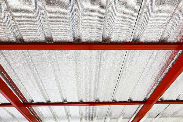Under metal sheet attached to the roof insulation