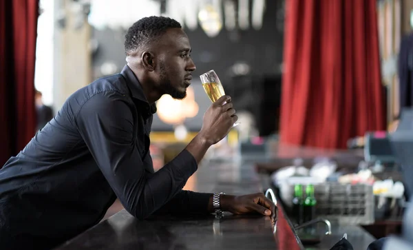 Portrait of confident African American businessman at nightclub.