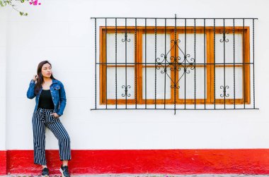 Karşı pencere açık havada poz şık genç kadın. Şık kıyafet. Güzel model gülümseyen