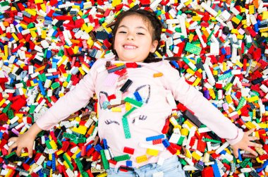 Eğitici oyuncak blokları ile küçük kız. Çocuk kreşe veya okul öncesi oyun. Çocuk odası içinde karışıklık.