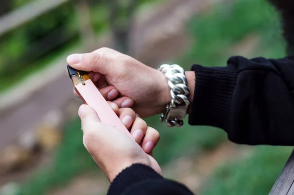 Close-up of person hand holding electronic cigarette