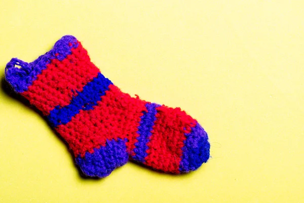 Knitted Woolen Sock Red Color Blue Stripes Yellow Background Seed — Stock Photo, Image