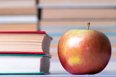 Gıda ve kitap, apple bir satırda yığılmış kitaplar yanındaki kırmızı kitap kapalı arka arka plan da kitaplar