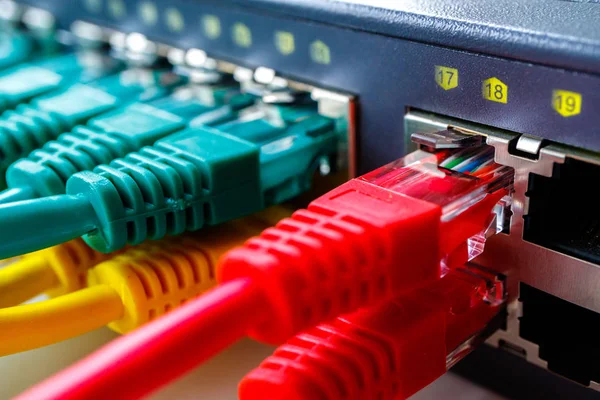 geçiş bağlantı noktalarına arka plan yeşil ve sarı patchcords, Internet erişim merkezi içinde takılı ön planda kırmızı kablolar