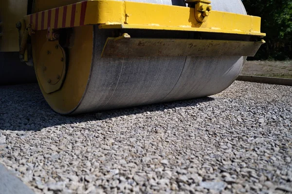 road roller performing road works on leveling of fresh asphalt, road works