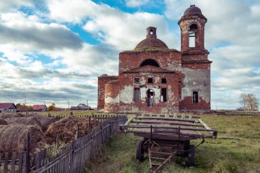 bulutlar atlar ve balya saman, Rus hinterland için ön plan eski arabası ile mavi gökyüzünün altında kırsal ve eski kilise yok