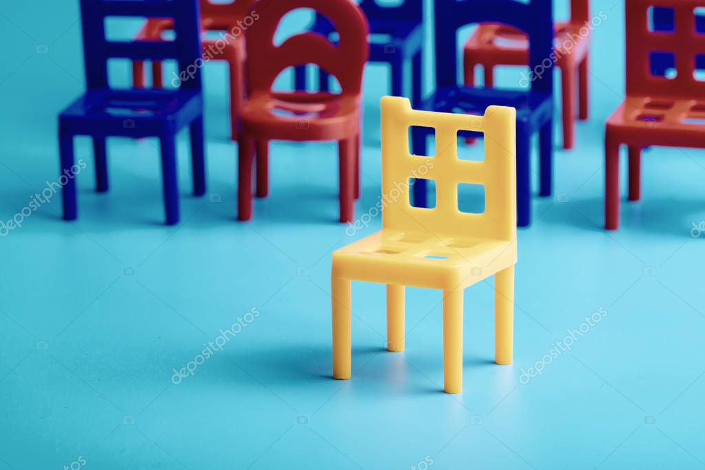 sobre un fondo azul silla amarilla detrás de ella otros colores, azul y