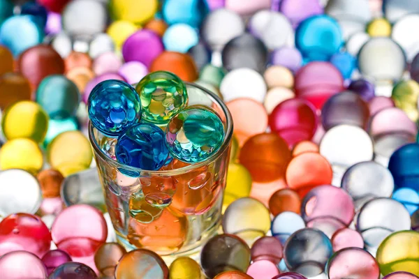 Among the mountain of multicolored hydrogel balls — Stock Photo, Image