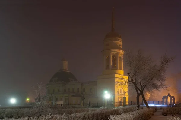 winter night with fog in fog yellow Church and lanterns