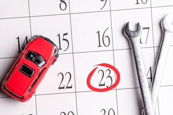 on the calendar circled the number 23 next to the number of red car and tools for nuts