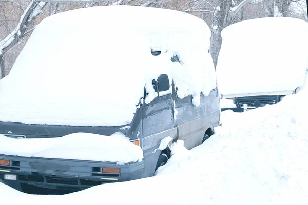 snow-covered cars after heavy snow