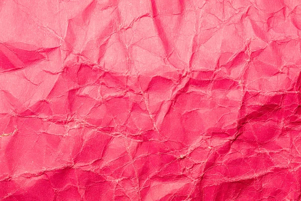 Close-up abstract background of strongly jammed purple cardboard. Crumpled paper surface Close-up.