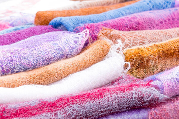 multi-colored down shawls in large quantities. sale of Russian shawls