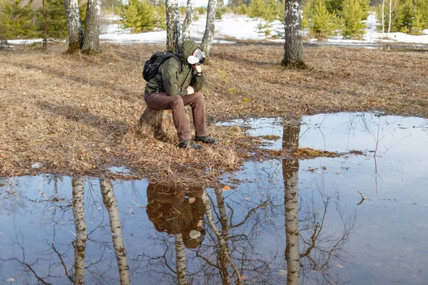 Man Gas Mask Sits Thought Stump Large Puddle Spring Melancholy Stock Picture