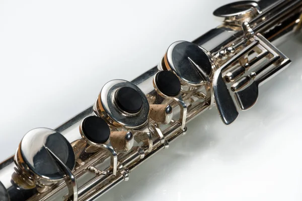 Details Silver Bass Flute Lying White Reflective Surface — Stock Photo, Image