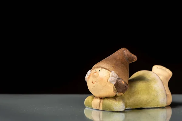 Small Figurine Gnome Lying Reflective Surface Black Background — Stock Photo, Image