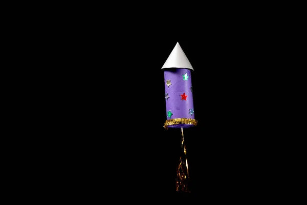 A rocket made of toilet paper roll by a child, black background — Stock Image Rocket Made Toilet Paper Roll Child Black Background Royalty Free Stock Images