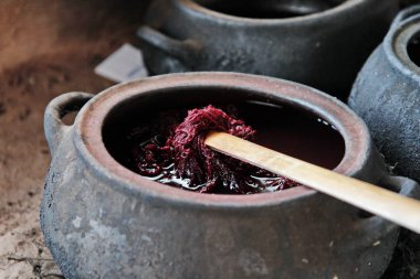 wool dyeing with natural dyeing agents clipart