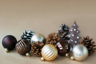 Bir dekoratif küçük el yapımı Noel ağacının etrafında hangi fotoğrafı yalan normal boyutuna Noel oyuncaklar ve çam kozalakları bej renkli bir arka plan üzerinde