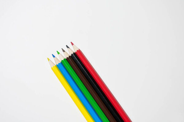 Photo of colored pencils lined up in a row at an angle on a white background